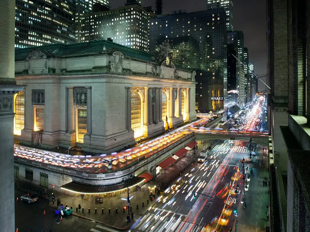 a large building with many lights on in the city
