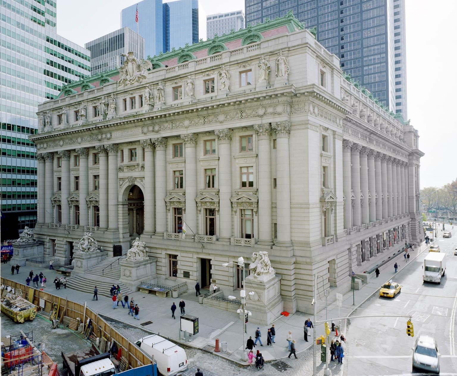 an old building with people walking around in front of it