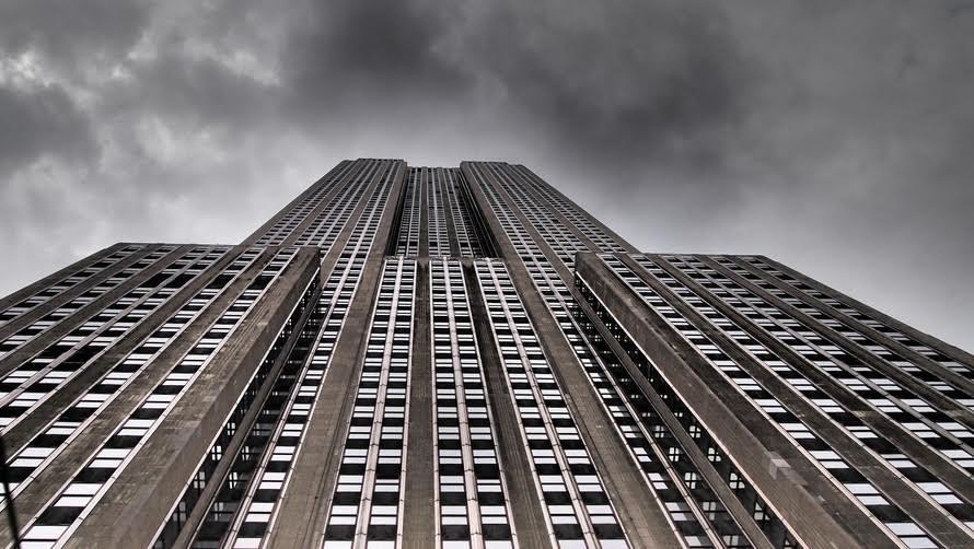 the top of a tall building under a cloudy sky