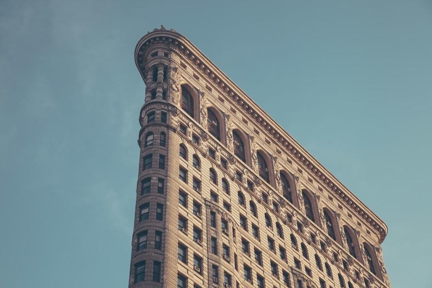 the top of a tall building against a blue sky