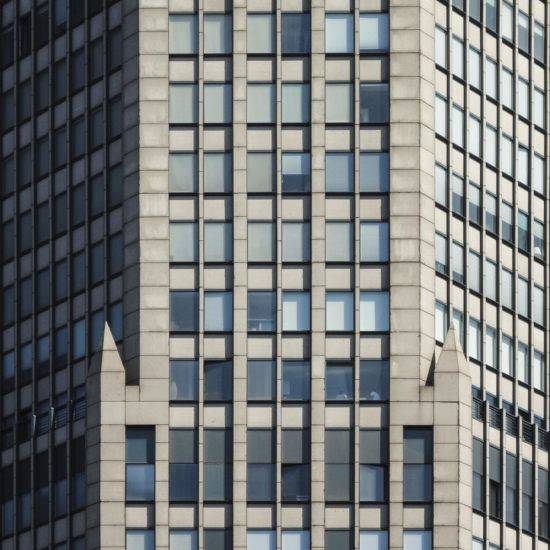 the top of a tall building with lots of windows