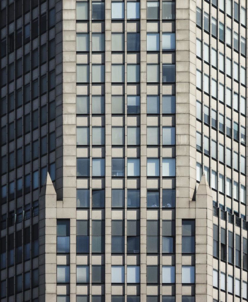 the top of a tall building with lots of windows