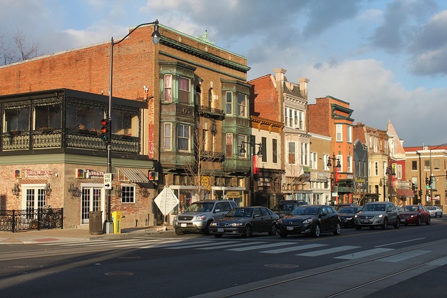 cars parked on the side of the road in front of buildings