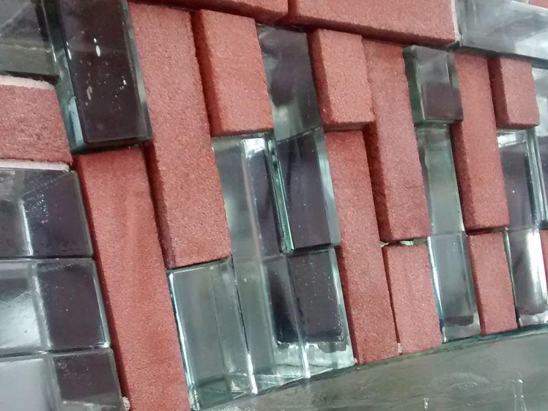 a red brick wall with glass blocks on it