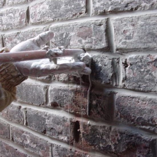 a brick wall with a pipe sticking out of it