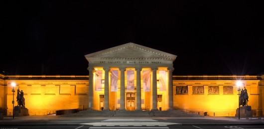 a large building with columns lit up at night