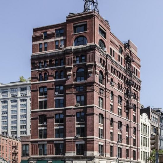 an old brick building with a water tower on top