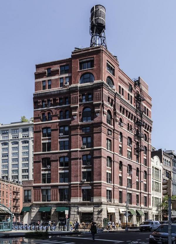 an old brick building with a water tower on top