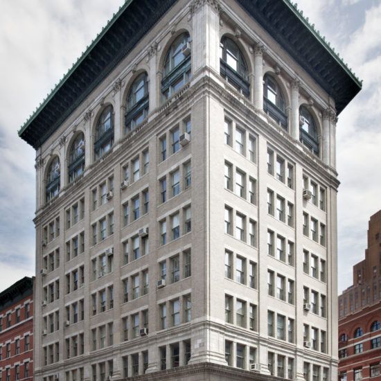 a large building with a tall tower on the corner