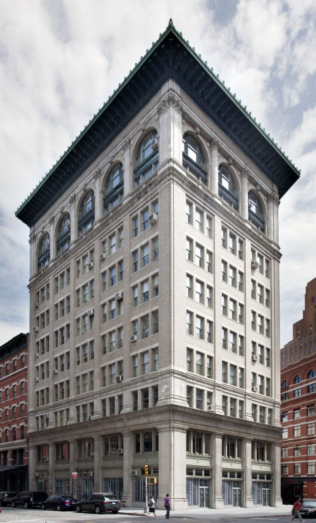 a large building with a tall tower on the corner