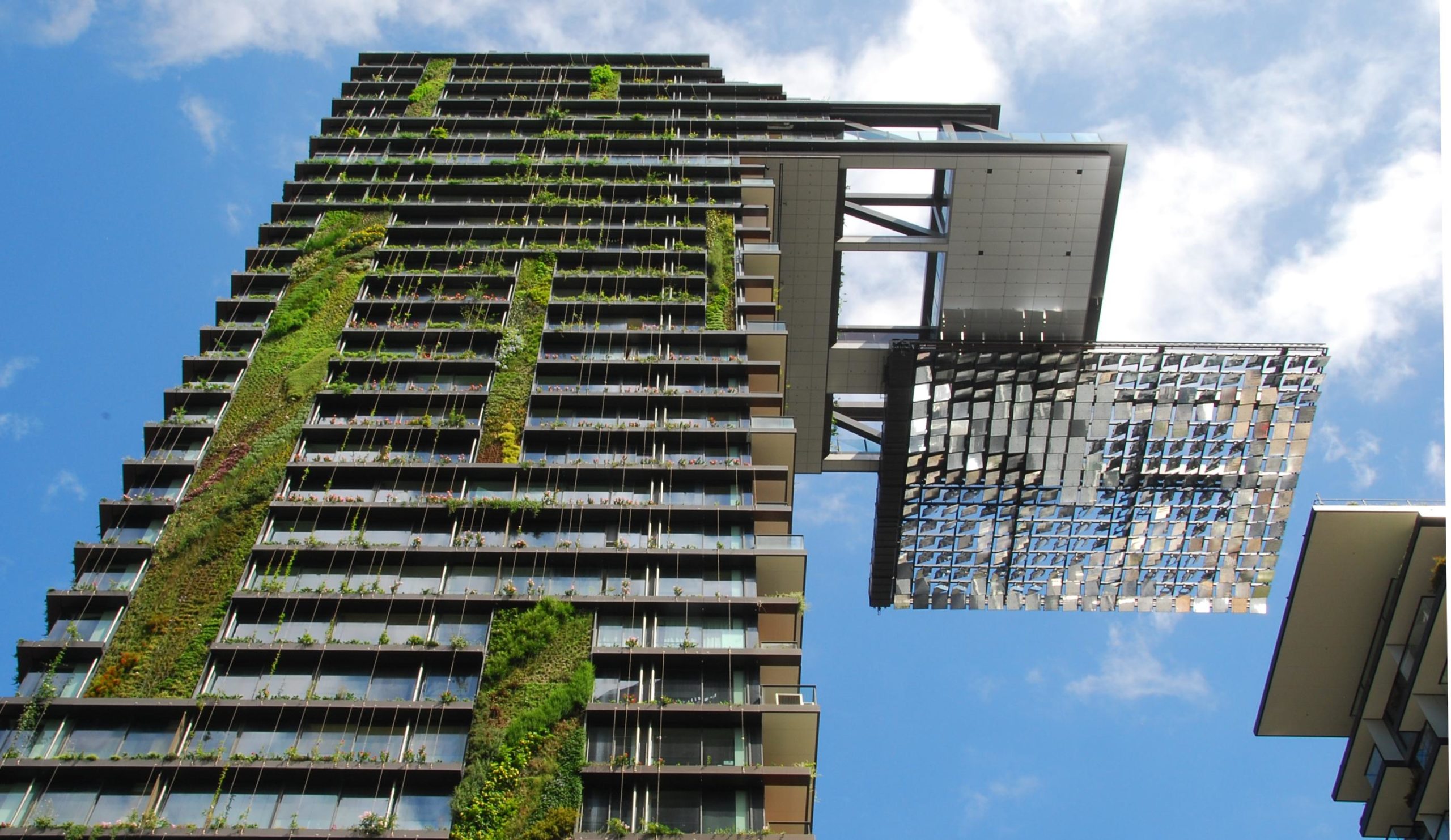 a tall building with plants growing on the side