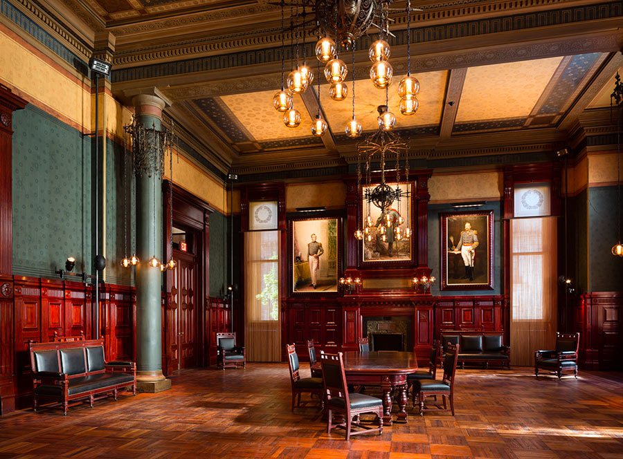 a large room with wood paneling and chandeliers