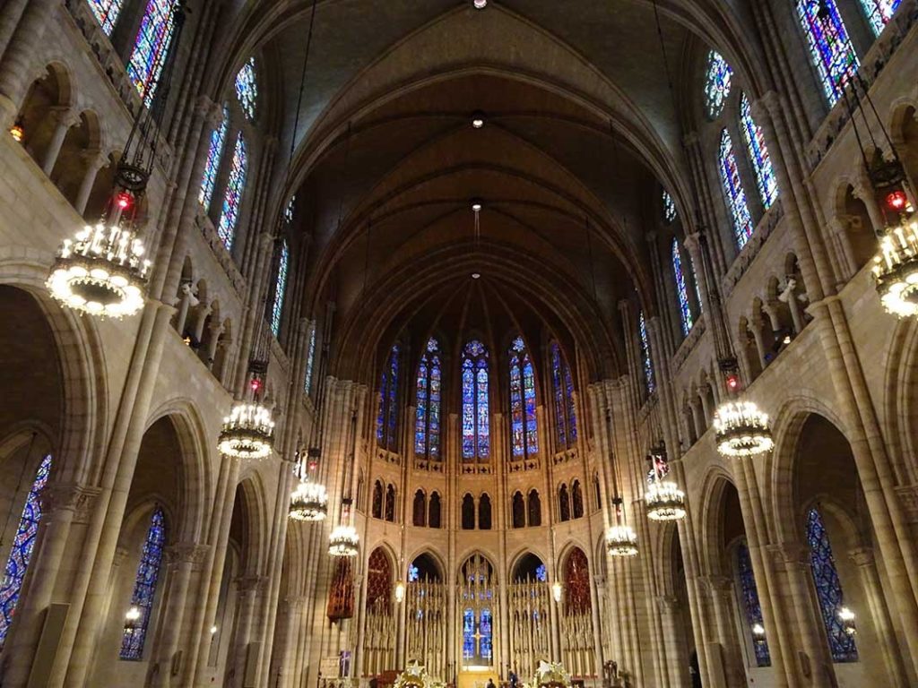the inside of a large cathedral with stained glass windows