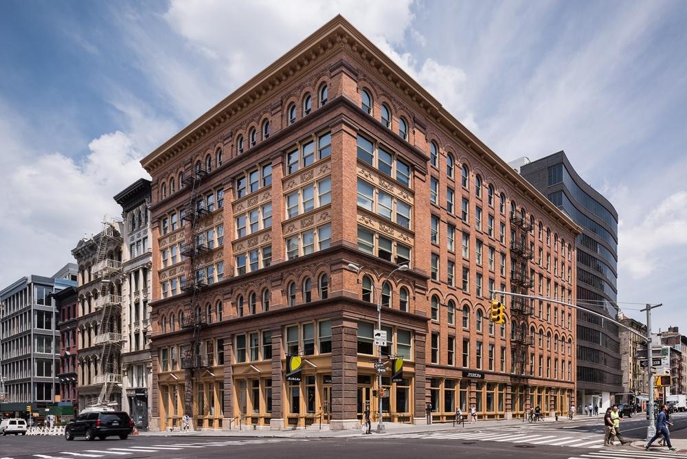 a large building on the corner of a city street