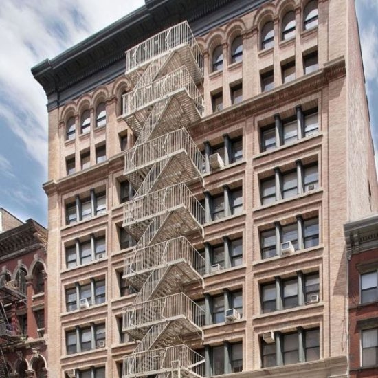 a very tall building with a spiral staircase in front of it