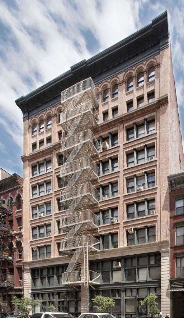 a very tall building with a spiral staircase in front of it