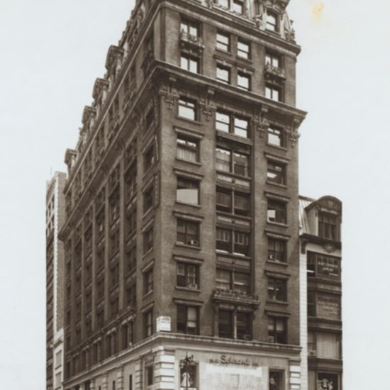 an old photo of a large building in the city
