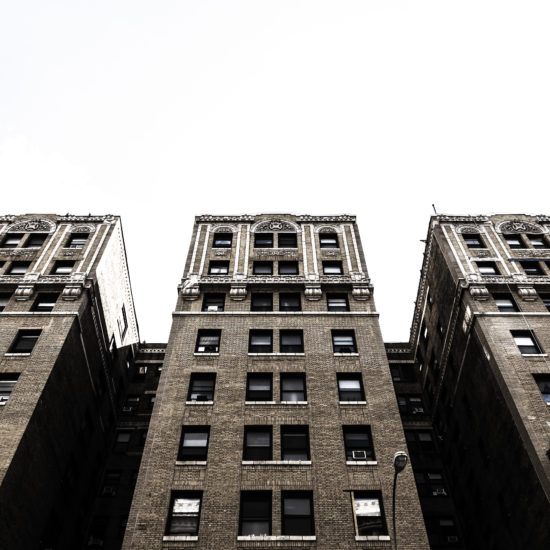 looking up at the top of two tall buildings