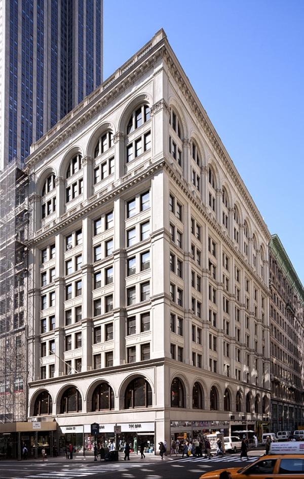 a large white building sitting on the corner of a street