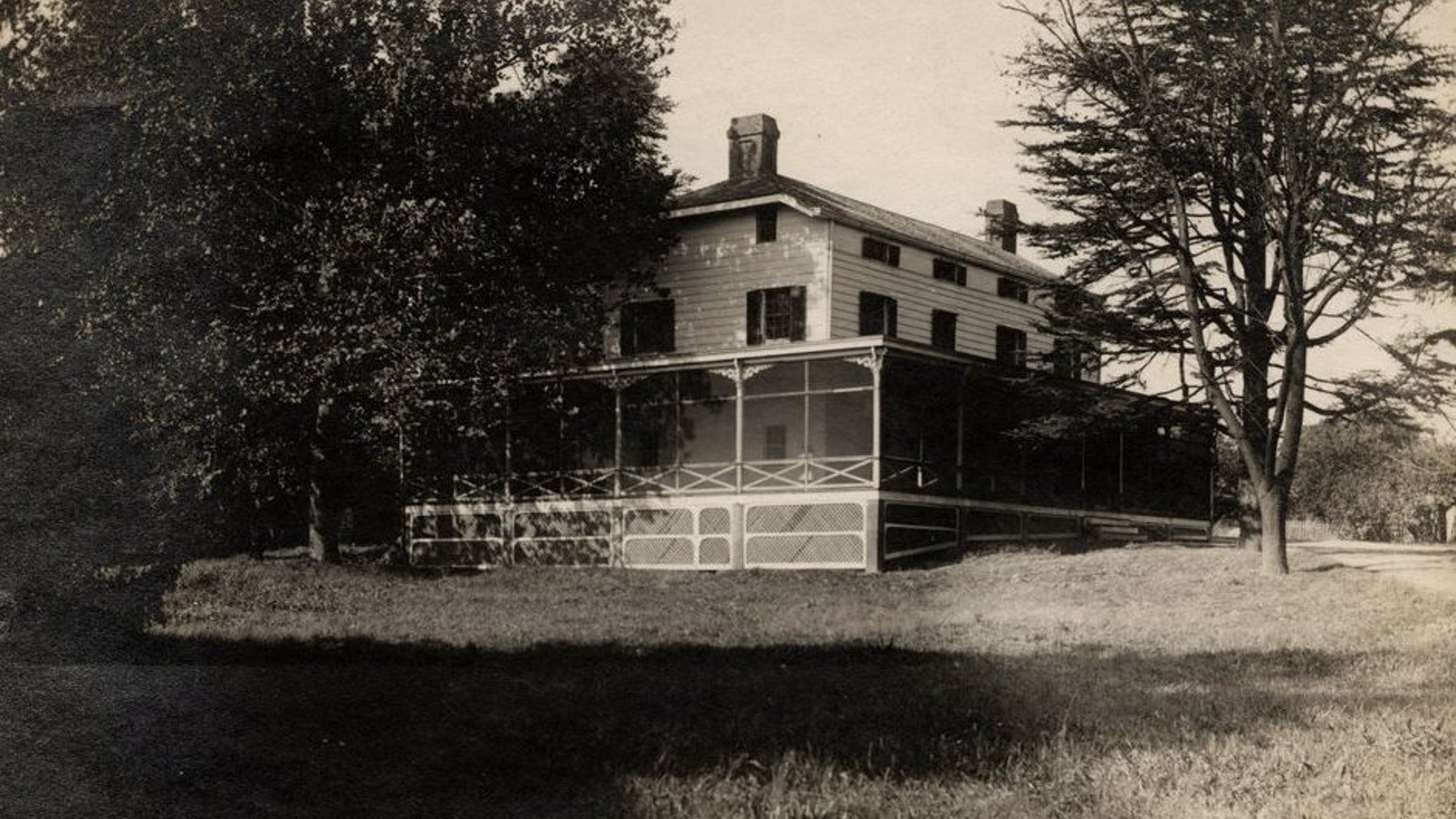 an old photo of a house in the woods