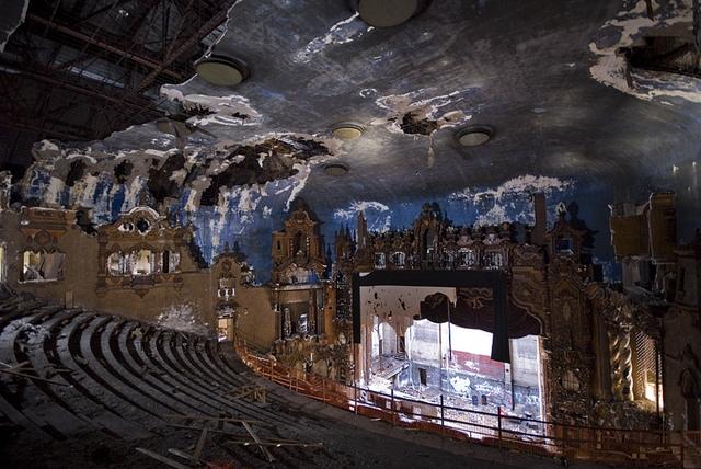 an abandoned theater with the stage broken down
