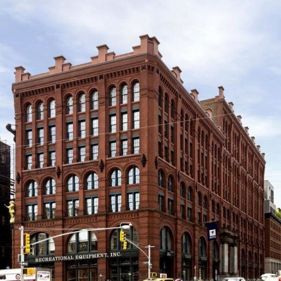 a large brick building on the corner of a street