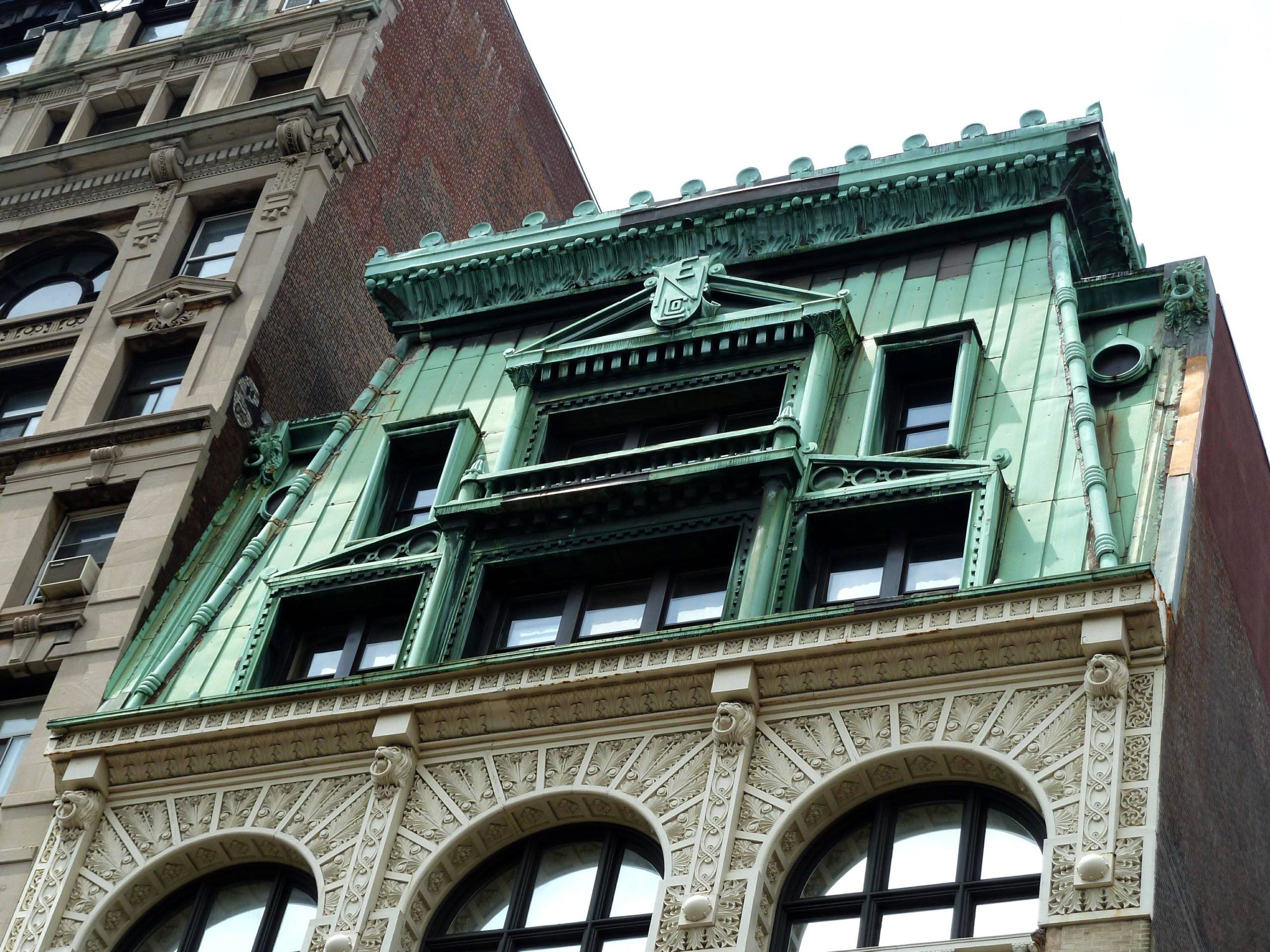 an old building with green roof and windows