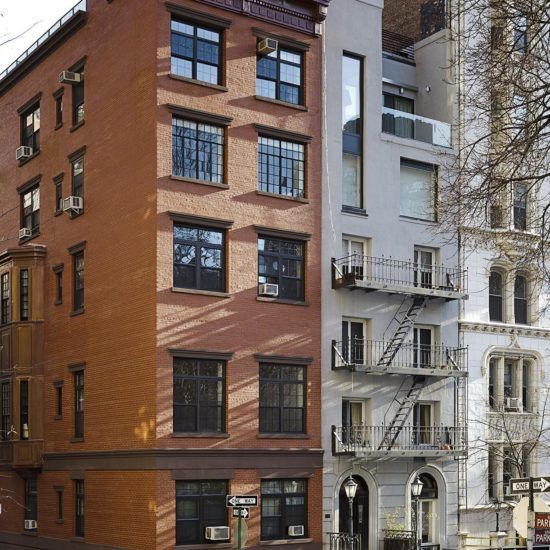 a tall brick building sitting on the side of a road