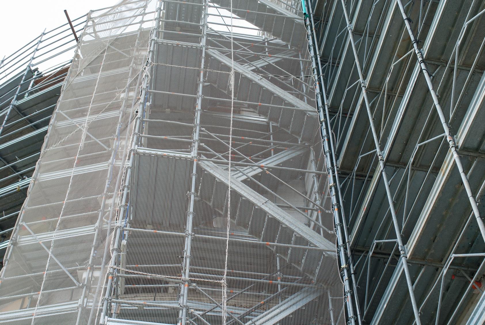 a tall building with scaffolding around it's sides