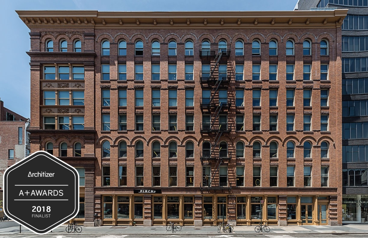 a large brick building with a clock on the front