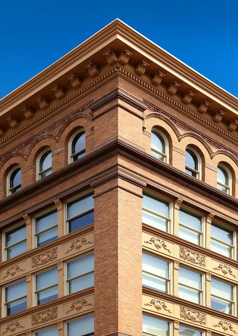 a tall building with many windows and a clock on it