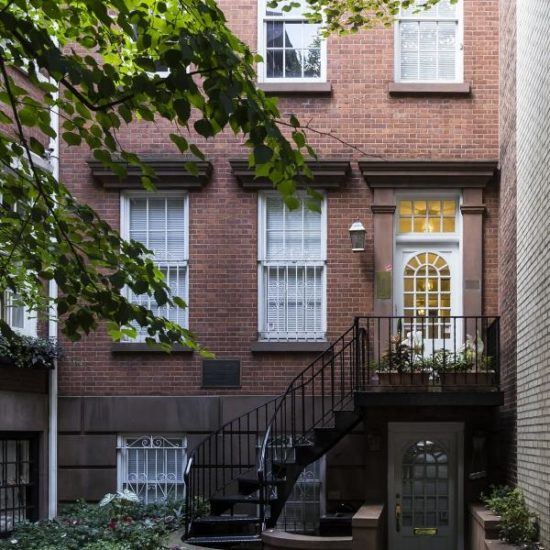 a building with stairs leading up to the front door