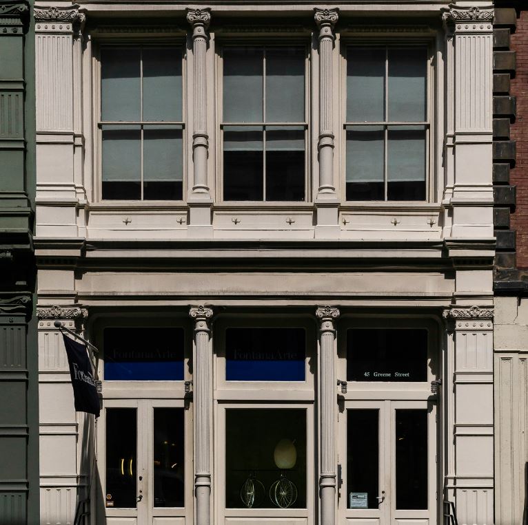 the front of a building with a clock on it's side