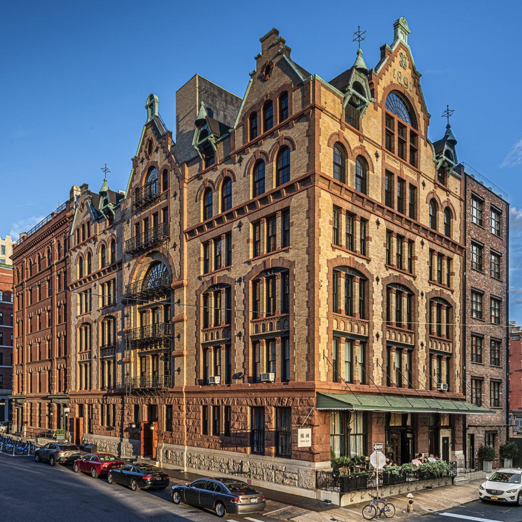 a large building with many windows and a clock on it