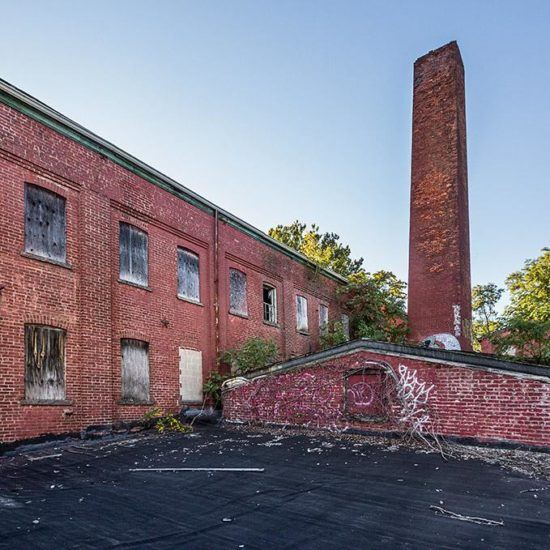 an old brick building with graffiti on it