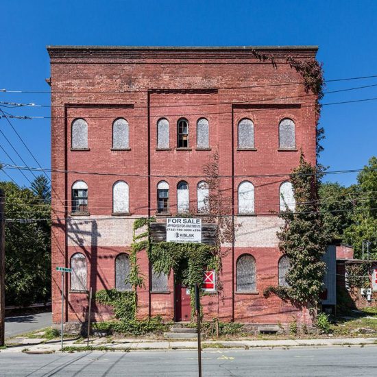 an old brick building on the corner of a street