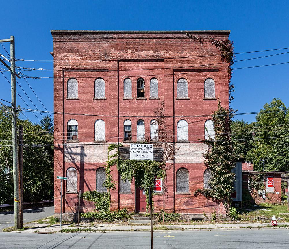 an old brick building on the corner of a street