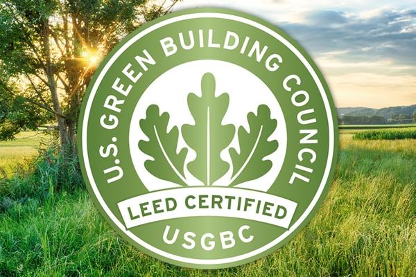 the green building council logo in front of a field