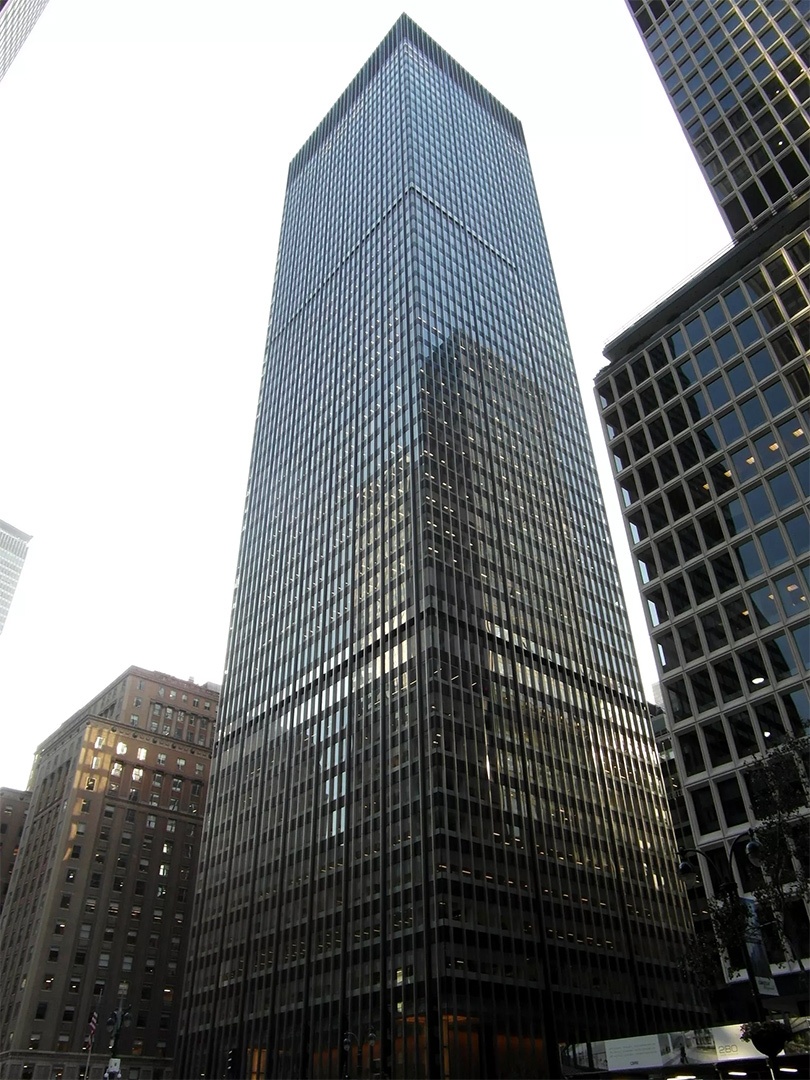 a very tall building with many windows in the city