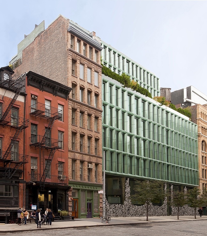 a row of buildings with people walking on the sidewalk