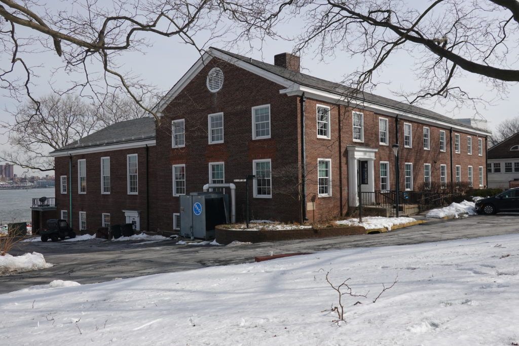 an old brick building with snow on the ground