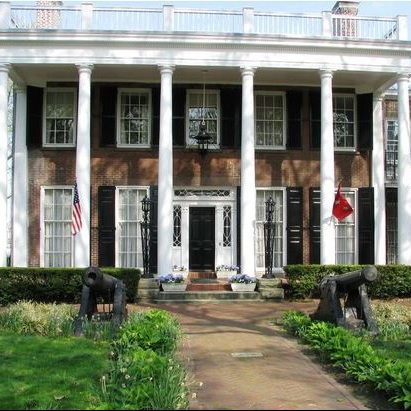 a large brick house with columns and pillars