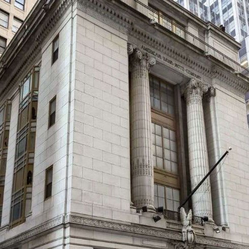 an old building with columns and windows in the city