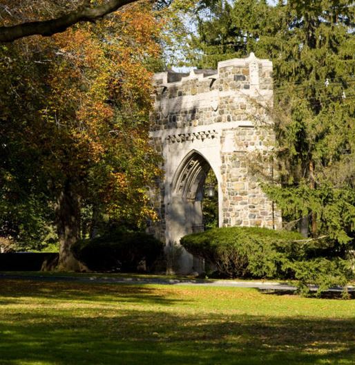 an old stone building surrounded by trees and grass