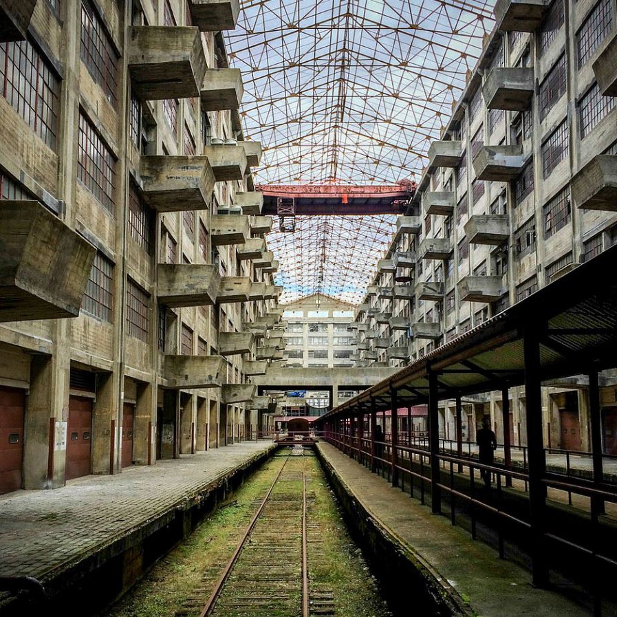 an empty train station with tracks in between the buildings