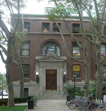 bicycles are parked in front of a brick building