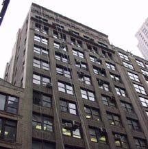 a tall building with lots of windows next to a traffic light