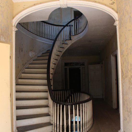 a spiral staircase in an abandoned building