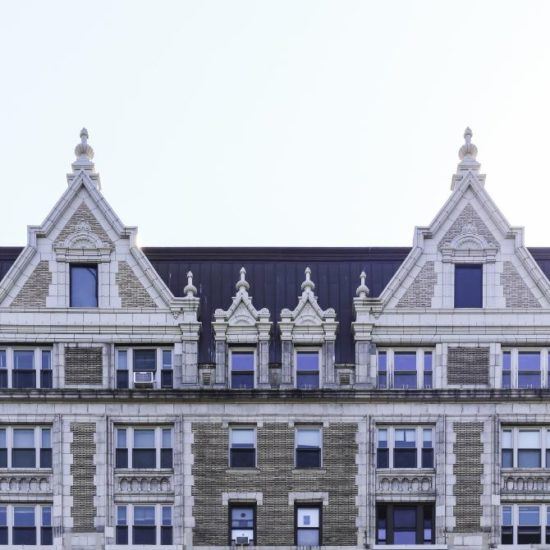 a large building with many windows and a clock on the front