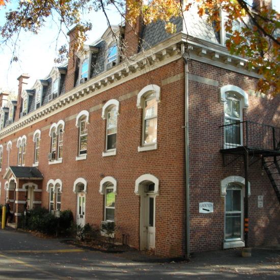 an old brick building on the corner of a street